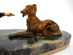 Medium sized "Chryselephantine" lady with Borzoi (Russian wolfhound), mounted on a Portoro marble base by Scali, France 1930s. Spelter and Ivoreen. Overall length 49 cm  19.30".