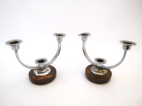 Pair of Art Deco Candle-stands. Each with circular dark brown wooden Support and 3 chromed Candleholders.